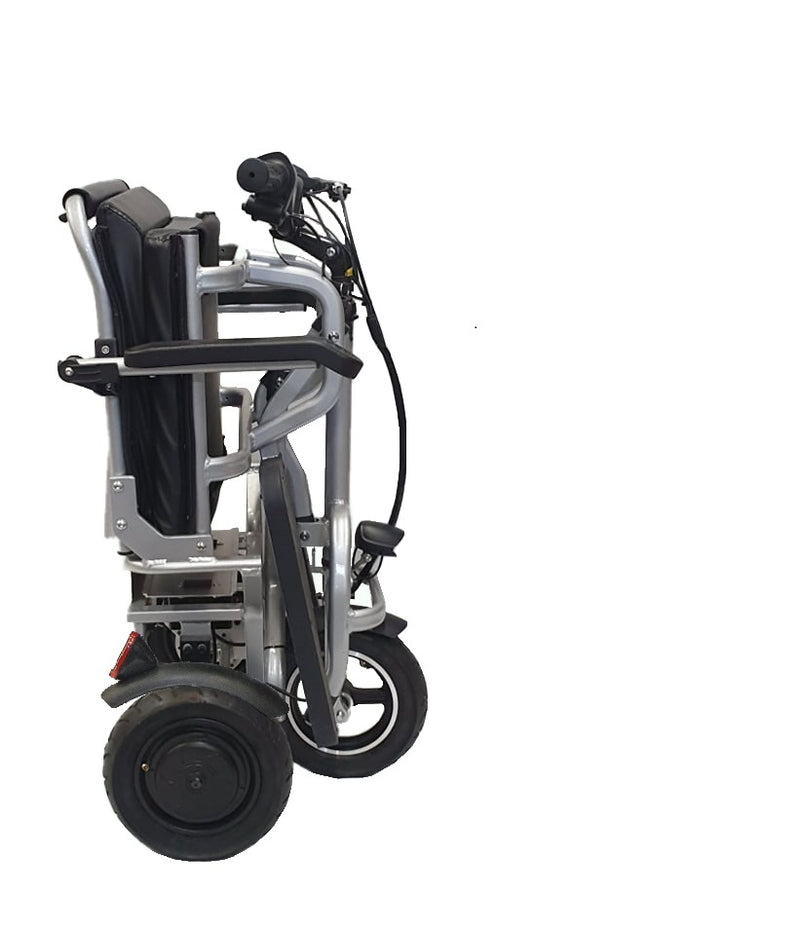 The scooter folded upright on its wheels, ready to be wheeled along like a suitcase
