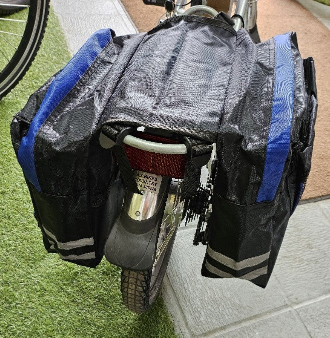 The double pannier from behind the bike, showing the reflective strips on both bags